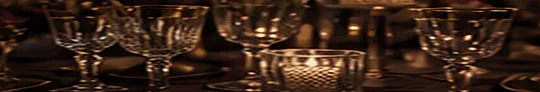 Cut crystal glassware and candles on a reception table