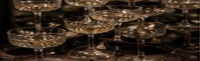 A champagne coupe tower catching candlelight